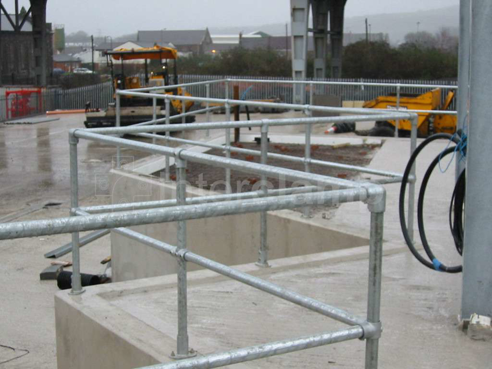 Recycling facility equipped with safety guardrailing constructed from Interclamp pipe clamp fittings and tubes, ensuring secure access for the public.